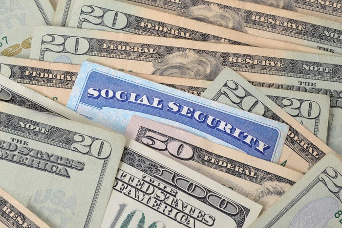 Social Security card in a spread-out pile of cash.