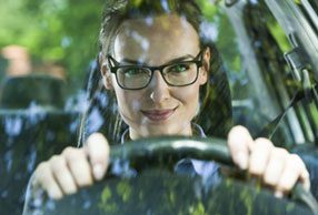 Woman driving while wearing driver glasses