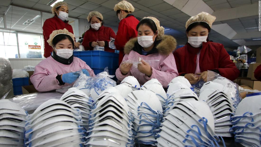 Workers manufacture protective face masks at a factory in China&#39;s Hubei Province on January 23.