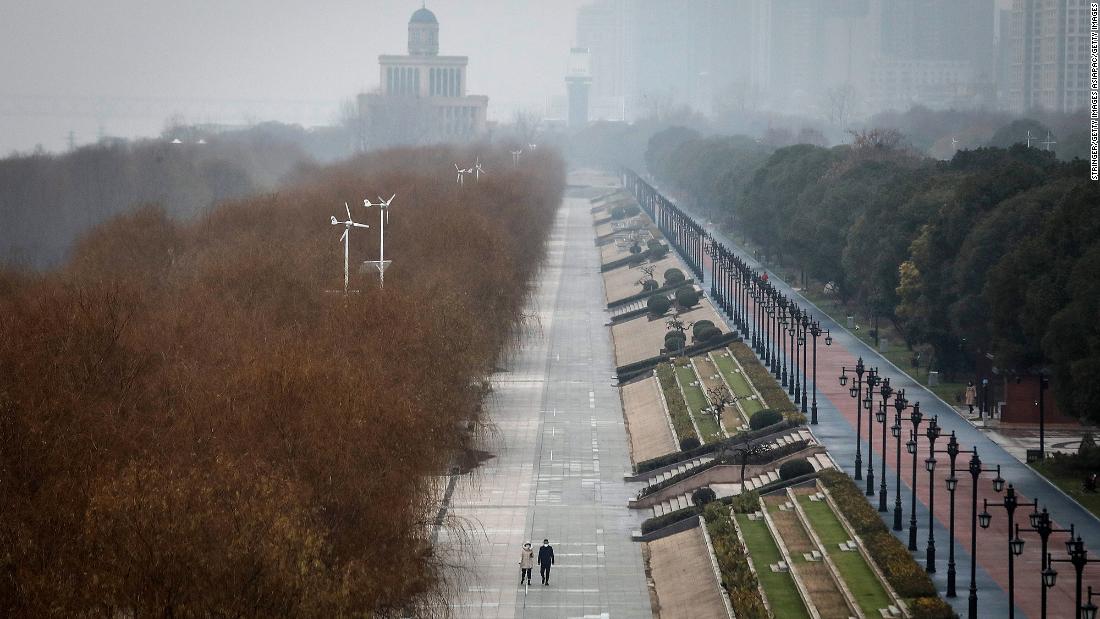 Two residents walk in an empty park in Wuhan on January 27. The city remained on lockdown for a fourth day.