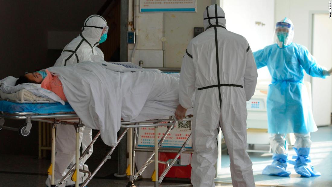 Medical workers move a coronavirus patient into an isolation ward at the Second People&#39;s Hospital in Fuyang, China, on February 1.