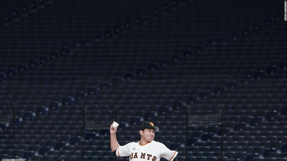 Tomoyuki Sugano, a professional baseball player on the Yomiuri Giants, throws a pitch in an empty Tokyo Dome during a preseason game on February 29. Fans have been barred from preseason games to prevent the spread of the coronavirus.