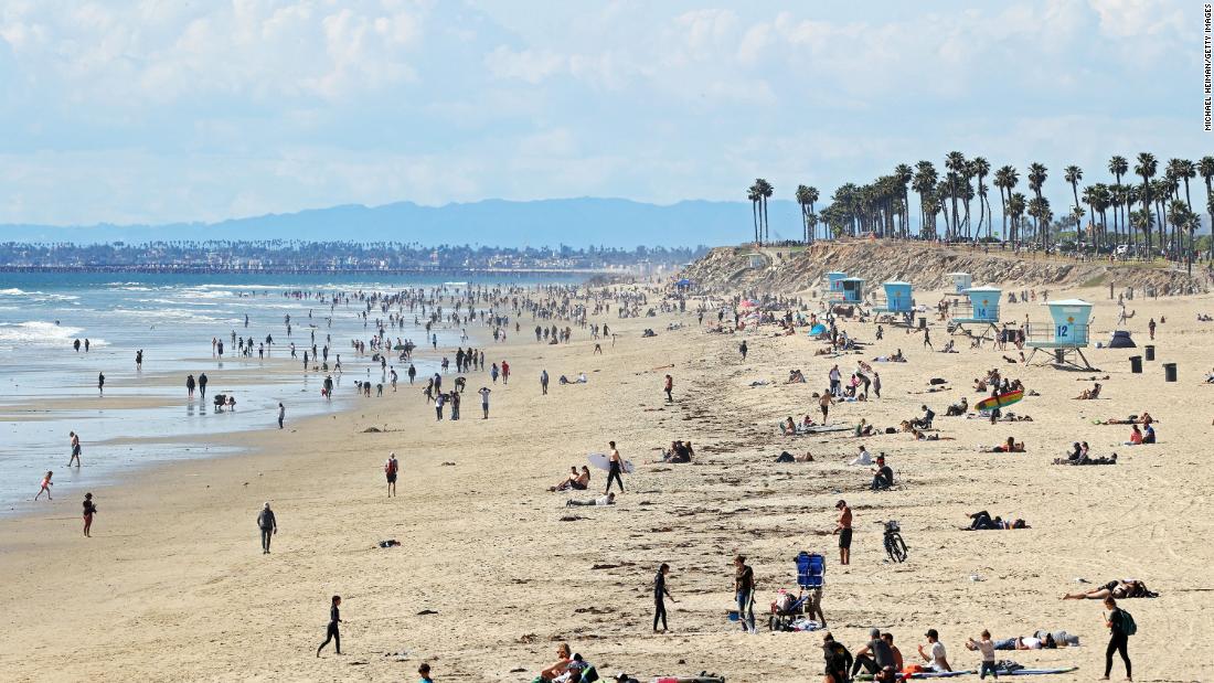 People are seen on California&#39;s Huntington Beach on March 21. Crowds descended on California beaches, hiking trails and parks over the weekend &lt;a href=&quot;https://www.cnn.com/2020/03/23/us/california-stay-at-home-beach-goers/index.html&quot; target=&quot;_blank&quot;&gt;in open defiance of a state order&lt;/a&gt; to shelter in place and avoid close contact with others.