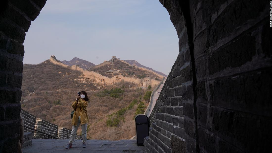 A tourist wears a face mask while visiting the Badaling section of the Great Wall of China on March 24. The section &lt;a href=&quot;https://www.cnn.com/travel/article/badaling-great-wall-china-reopens-intl-hnk/index.html&quot; target=&quot;_blank&quot;&gt;reopened&lt;/a&gt; to visitors after being closed for two months.