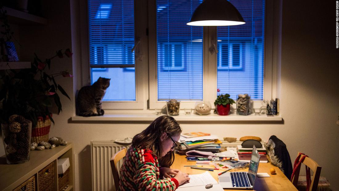 A student does homework in Bratislava, Slovakia, on March 27. Schools have been shut down across the world, and many children have been receiving their lessons online.