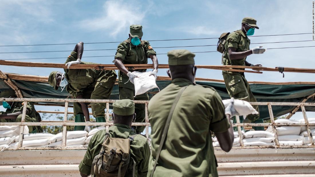 Paramilitary members unload provisions in Kampala, Uganda, on Saturday, April 4. It was the first day of government food distribution for people affected by the nation&#39;s lockdown.