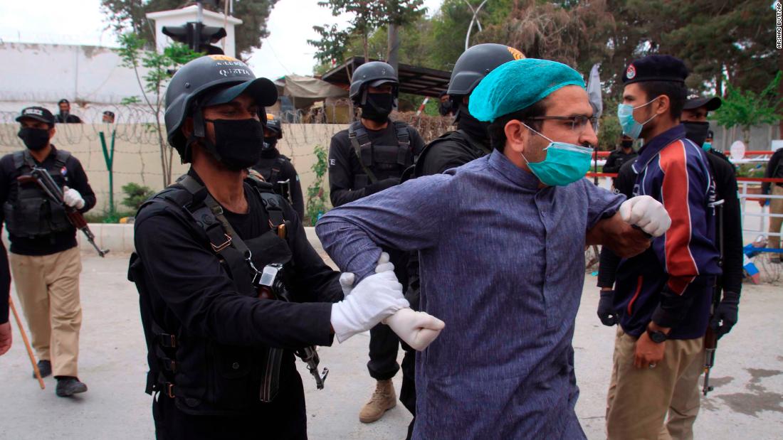 Police detain a doctor in Quetta, Pakistan, who was among dozens of health care workers protesting a lack of personal protective equipment on April 6.