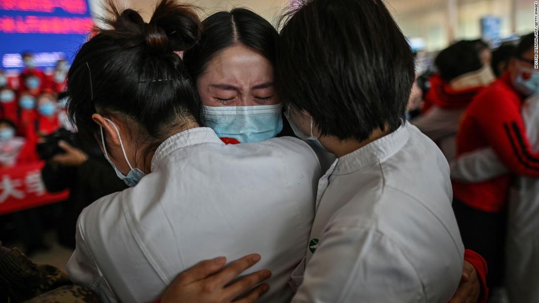 A medical staff member from China&#39;s Jilin province, center, cries while hugging nurses from Wuhan on April 8. Wuhan was &lt;a href=&quot;https://www.cnn.com/2020/04/07/asia/coronavirus-wuhan-lockdown-lifted-intl-hnk/index.html&quot; target=&quot;_blank&quot;&gt;reopening its borders&lt;/a&gt; after 76 days.