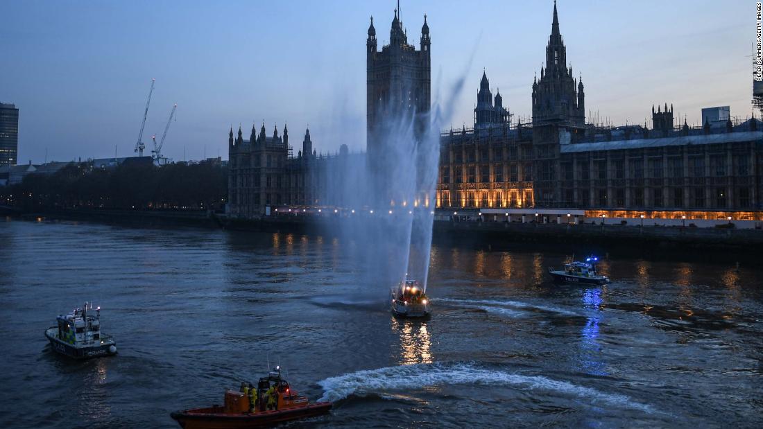 Service boats spray water in London to show support for health care workers on April 9.