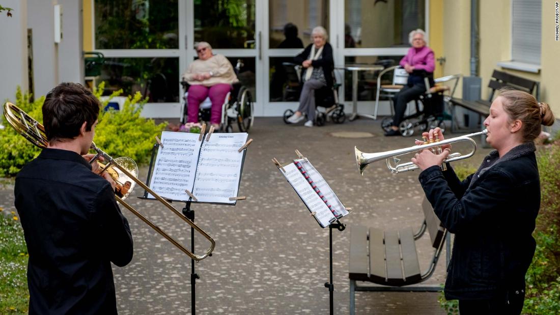 Musicians play their instruments for a retirement home in Karben, Germany, on April 13.