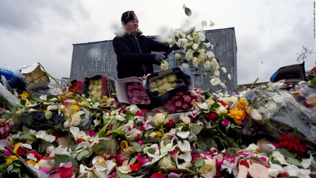 A flower shop employee destroys unsold flowers in St. Petersburg, Russia, on April 13.