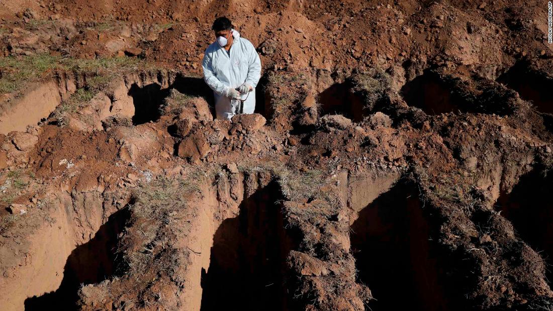 A cemetery worker pauses while digging graves at the San Vicente cemetery in Cordoba, Argentina, on April 14.