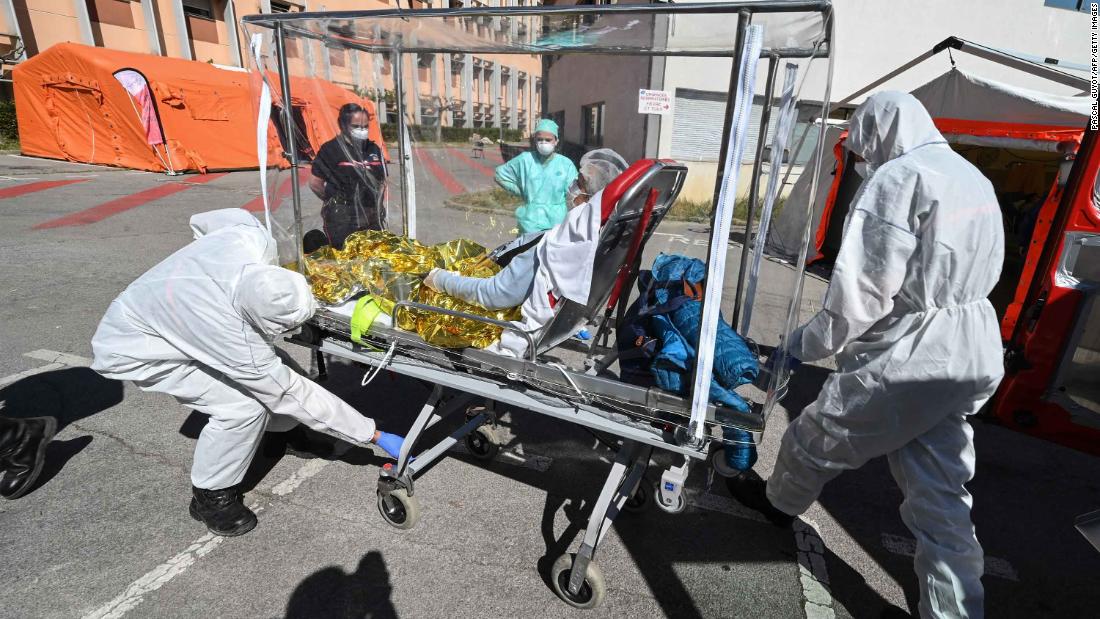 Firefighters transfer a patient from an ambulance in Montpelier, France, on April 14.