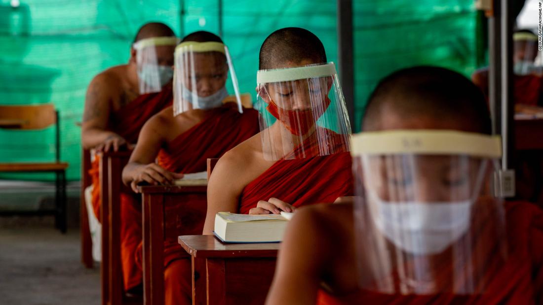 Novice Buddhist monks wear face shields at the Molilokayaram Educational Institute in Bangkok, Thailand, on April 15.