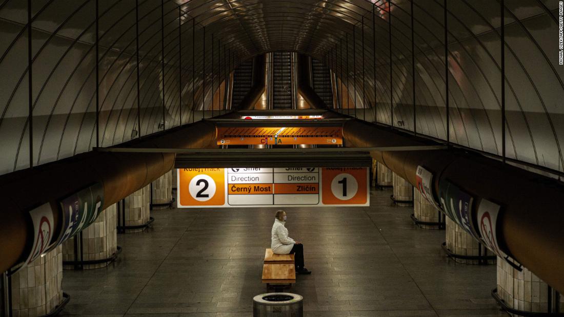 A woman sits on a bench at an empty metro station in Prague, Czech Republic, on April 15.