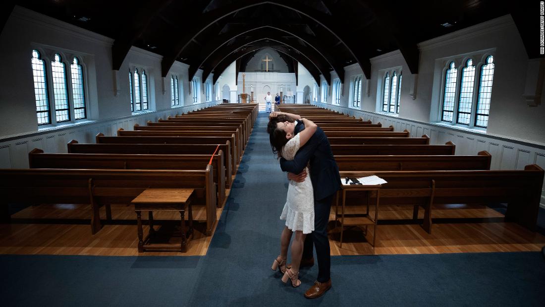 Newly married Tyler and Caryn Suiters embrace following their marriage ceremony in Arlington, Virginia, on April 18. The Rev. Andrew Merrow and his wife, Cameron, were the only other attendees at the ceremony, which was held at St. Mary&#39;s Episcopal Church.