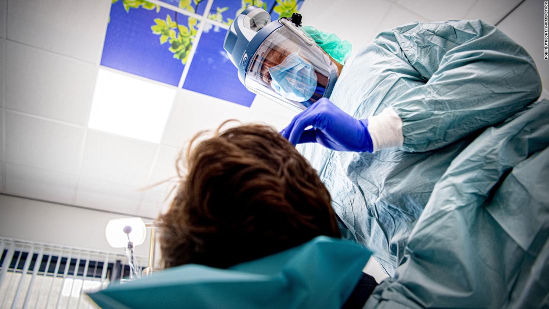 A dentist wears protective equipment while treating a patient in Den Bosch, Netherlands, on April 22.