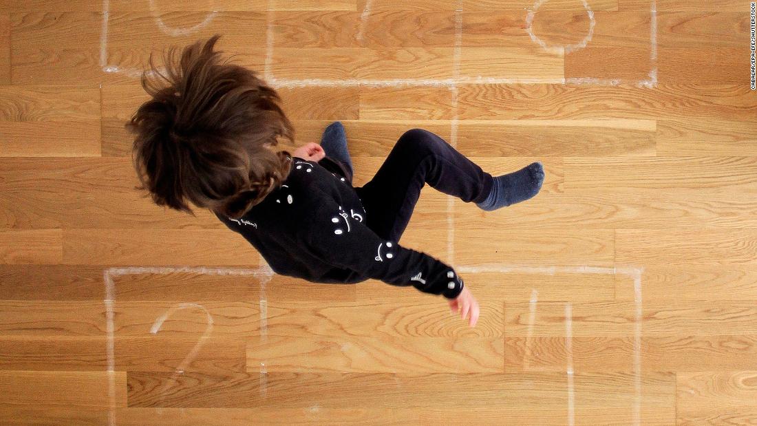 A boy plays hopscotch at his home in A Coruna, Spain, on April 23. 
