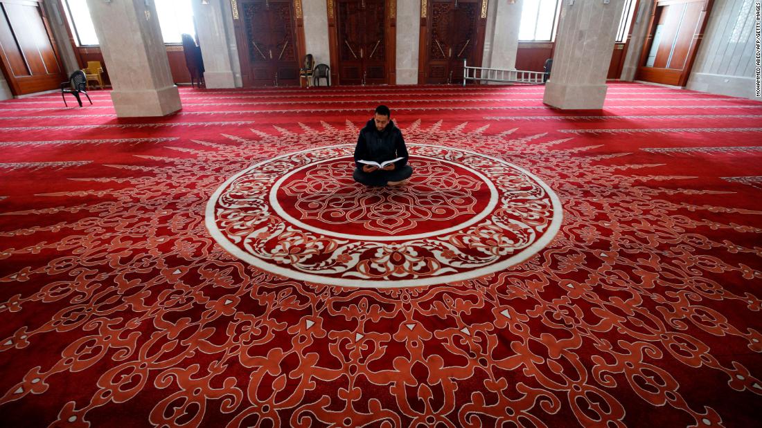 A muezzin, the person at a mosque who calls Muslims to daily prayers, reads the Quran at a mosque in Gaza City after &lt;a href=&quot;http://www.cnn.com/2020/04/23/world/gallery/ramadan-2020/index.html&quot; target=&quot;_blank&quot;&gt;Ramadan began&lt;/a&gt; on April 24.