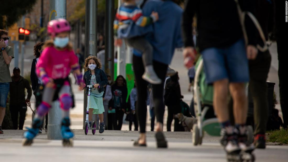Families walk along a boulevard in Barcelona, Spain, on April 26. The government now allows children&lt;a href=&quot;https://www.cnn.com/world/live-news/coronavirus-pandemic-04-26-20-intl/h_7d4e57bbfadc52a651f777cc7cff219c&quot; target=&quot;_blank&quot;&gt; to go out once a day,&lt;/a&gt; for one hour, within about half a mile of their homes, with one adult who lives with them. Up to three kids can go with each adult.