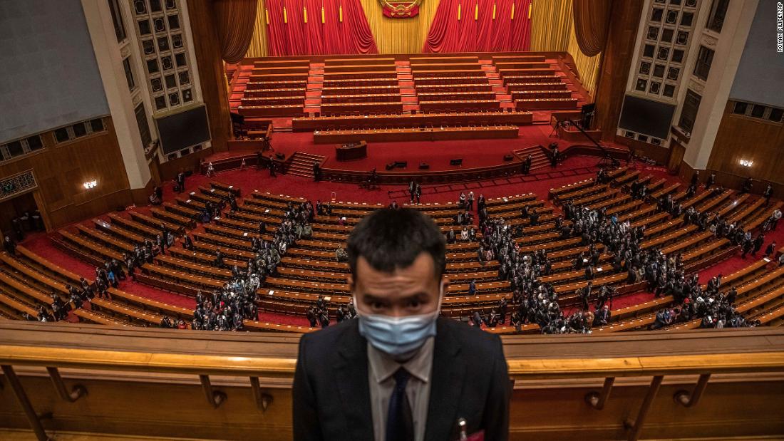 A security official stands guard at the Great Hall of the People in Beijing as delegates leave the second plenary session of the National People&#39;s Congress.