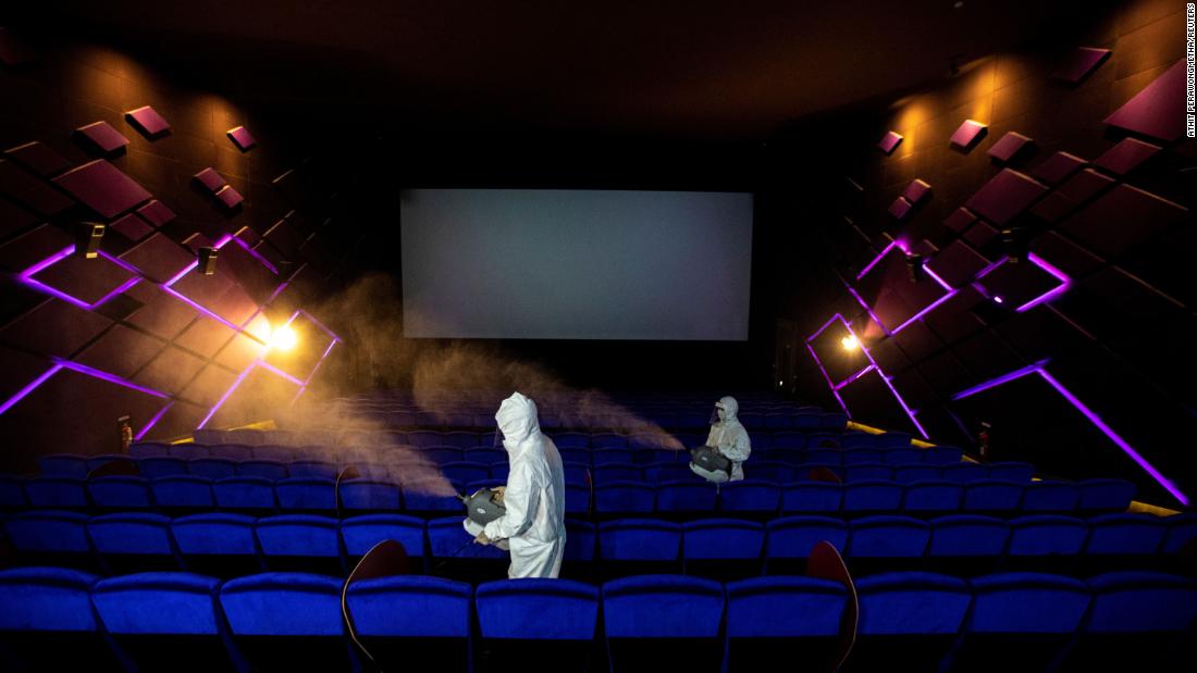 Workers spray disinfectant inside a movie theater in Bangkok, Thailand, ahead of its reopening on May 31. 