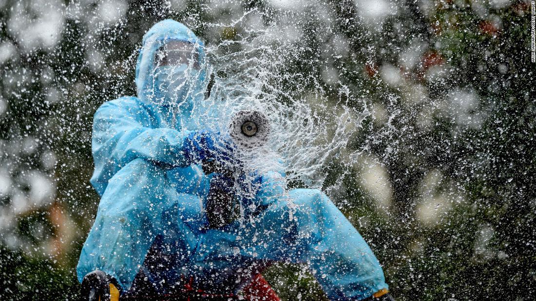 A firefighter in Chennai, India, sprays disinfectant to help prevent the spread of the coronavirus on June 11.