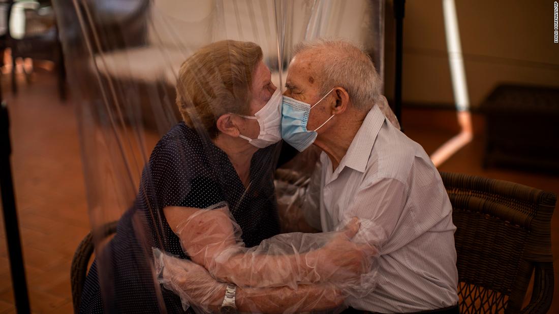 Agustina Cañamero and Pascual Pérez kiss each other through a plastic screen at a nursing home in Barcelona, Spain, on June 22. They&#39;ve been married for 59 years.