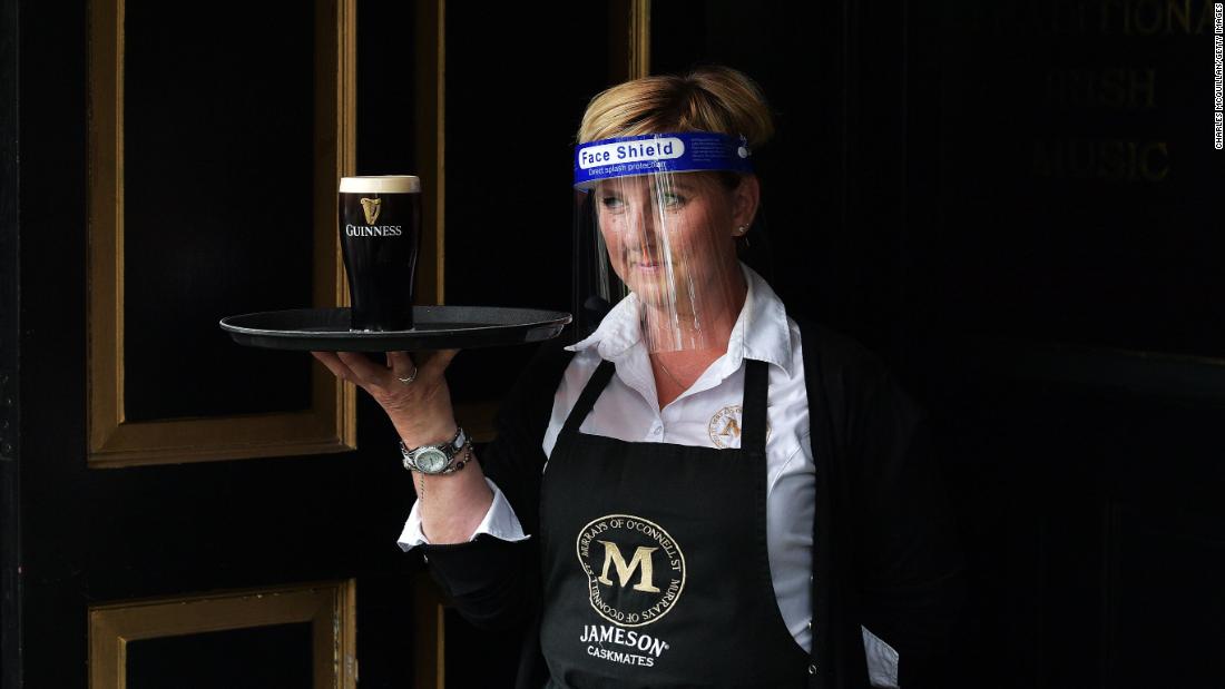 A member of the bar staff at Murray&#39;s Pub serves a pint of Guinness in Dublin, Ireland, on June 29. People in Ireland are tentatively returning to shops, hair salons and restaurants &lt;a href=&quot;https://www.cnn.com/travel/article/ireland-reopens-blarney-stone-scli-intl/index.html&quot; target=&quot;_blank&quot;&gt;as the country emerges from its coronavirus lockdown.&lt;/a&gt;
